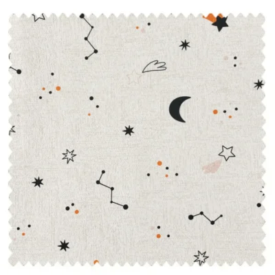 Fabric swatch with moon, stars, and constellation patterns on beige background