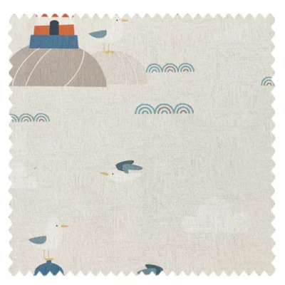 Fabric swatch with lighthouse, ocean waves, and fish motifs on a beige background
