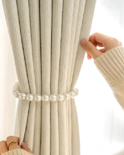 Close-up of decorative beaded tieback on light grey curtain from Ivory Breeze Collection