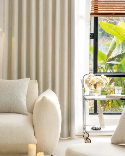 Ivory Breeze curtain softly draping in a sunlit modern living room with neutral decor