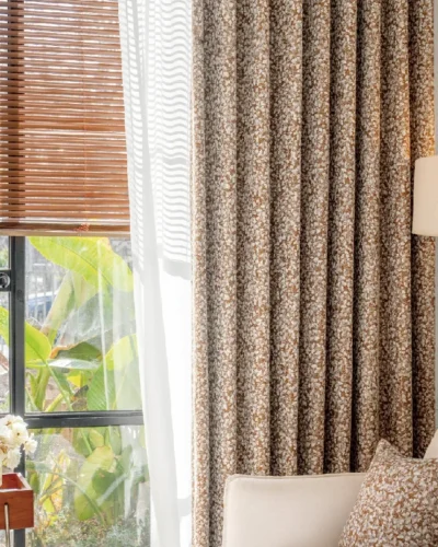 Floral Realm curtain in jacquard texture, shown in a cozy living room with wooden blinds and warm lighting.