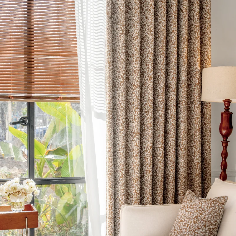 Floral Realm curtain in jacquard texture, shown in a cozy living room with wooden blinds and warm lighting.
