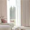 Soft mosaic jacquard curtain in pastel pink hanging in a cozy modern living room