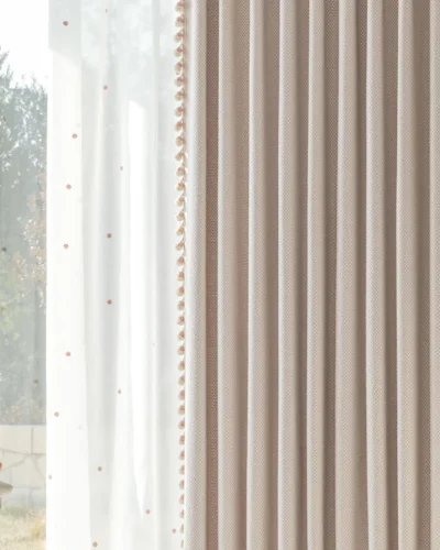 Close-up of pink mosaic jacquard curtain showing geometric texture and pleat detail