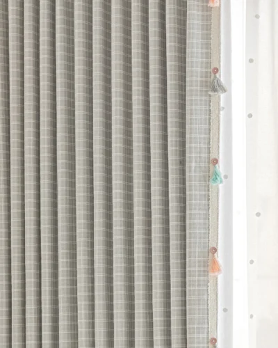 Close-up of Whisper Glow Curtain showing plaid jacquard texture and layered sheer curtain with tassels