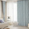 Sky blue jacquard curtain hanging in a modern living room with soft lighting