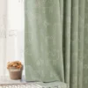 Close-up of Forest Dream Curtain in green animal jacquard fabric with giraffe and bear motifs for kids’ rooms