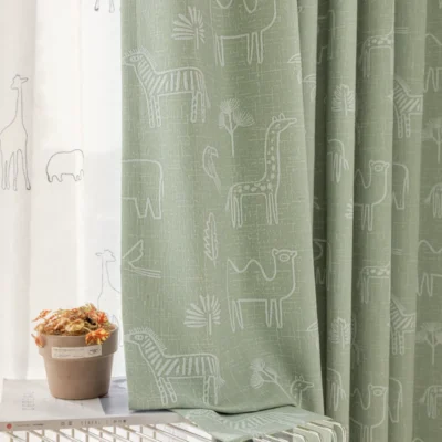 Forest dream curtain in green with animal jacquard fabric featuring giraffe and bear patterns – styled in kids' room