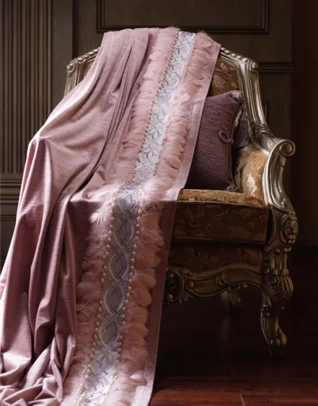 Dusty pink jacquard curtain fabric draped over antique chair