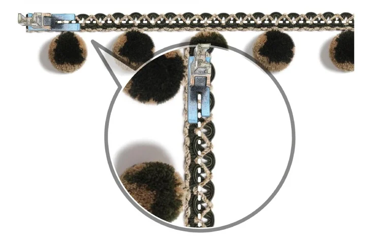 Close-up of braided curtain trim with plush pom pom fringe in brown and black