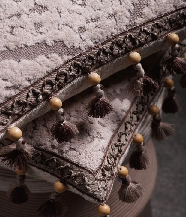 Layered Drapery Fabrics with Wood Bead Tassel Trims in Earth Tones