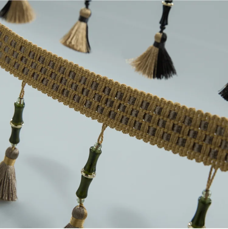 Curtain tassel trim with moss green cords and beige tassels in bamboo-style band