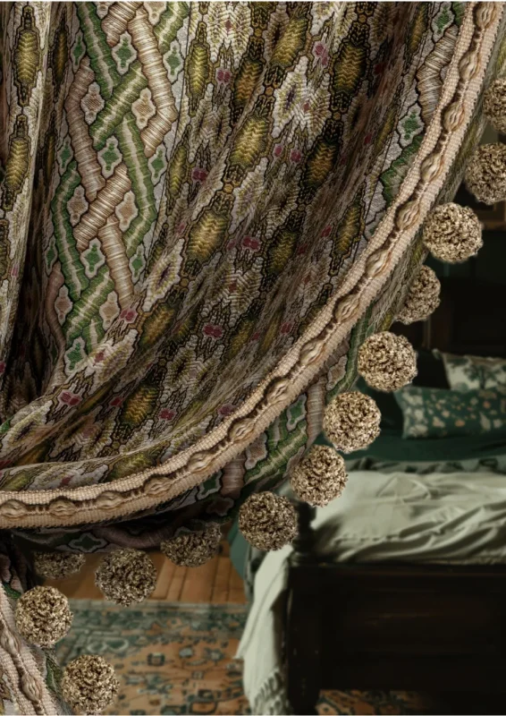 Woven Meadow Pom Pom Trim on patterned curtain – decorative fringe detail in vintage-style interior
