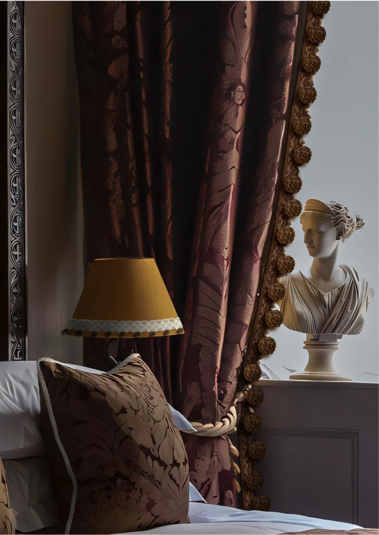 Dark floral drapery with golden pom pom fringe in a classical interior