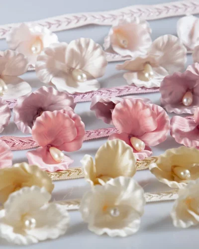 Multicolor 3D floral lace trim with pearl centers in pink, cream, and yellow tones