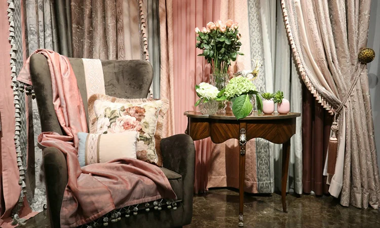 Romantic living room with pink curtains, floral armchair, and elegant decor