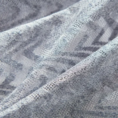 Zigzag sheer curtains hanging in a modern room, textured light voile in soft gray tones