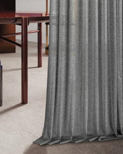 Designer ripple sheer curtain in gray, gently flowing to the floor with textured light filtering.