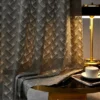 Serene Weave Sheer Curtain in dark jacquard texture under warm lamp lighting