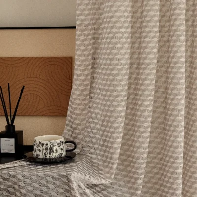 Warm beige jacquard sheer curtain with textured geometric pattern in cozy bedroom setting