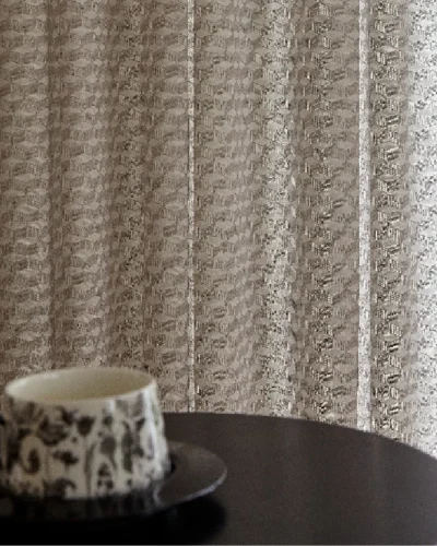 Jacquard curtain backdrop with coffee cup on table