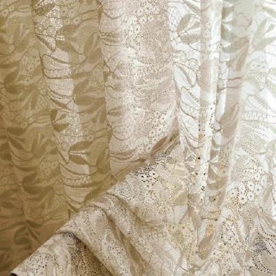 Close-up of dual-tone jacquard sheer curtain with leaf pattern in beige tone.