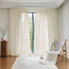 Soft white jacquard sheer curtain with scale-like pattern hanging in a minimal living space