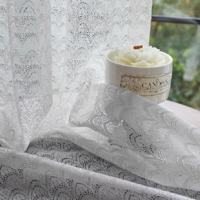 White jacquard sheer curtain with feather wave pattern near window and candle