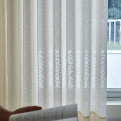 Echo Leaf layered jacquard curtain held by hand, showing texture and light filtering effect