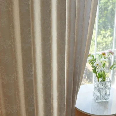 Soft jacquard curtain panel with floral texture beside window and vase