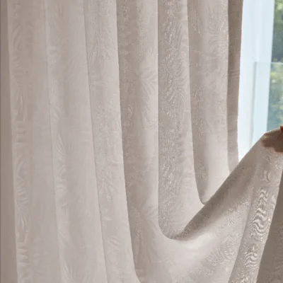 Close-up view of botanical jacquard texture on sheer curtain in natural light