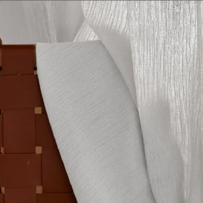 Soft chenille sheer curtain with a textured drape hanging in a cozy, modern space