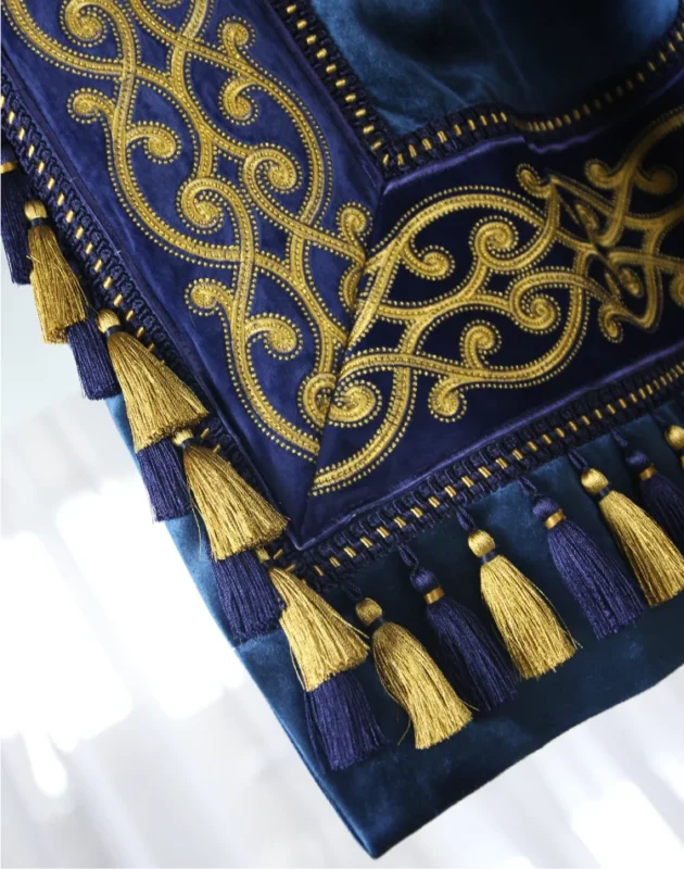 Luxurious navy and gold curtain with tassel trim and baroque embroidery