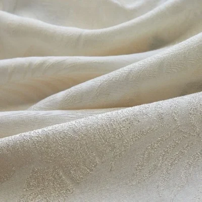 Close-up of botanical jacquard sheer curtain softly draping with filtered sunlight