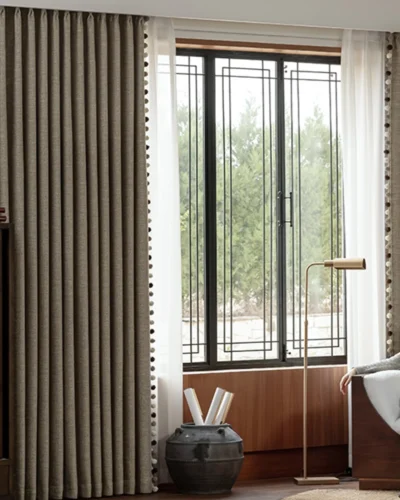 Chenille curtains in warm cocoa jacquard hanging beside a large window in a modern room