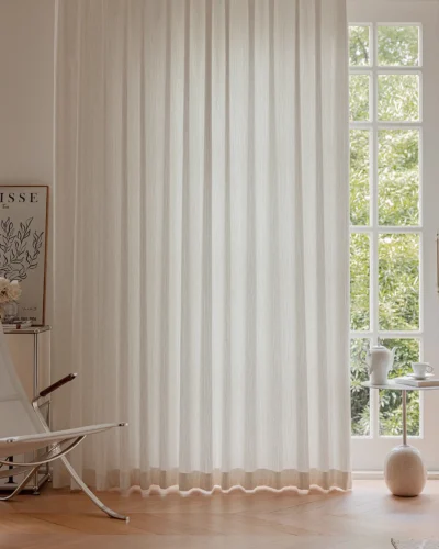 Ridge Texture Curtain – soft cream textured curtain filtering light at a window with greenery