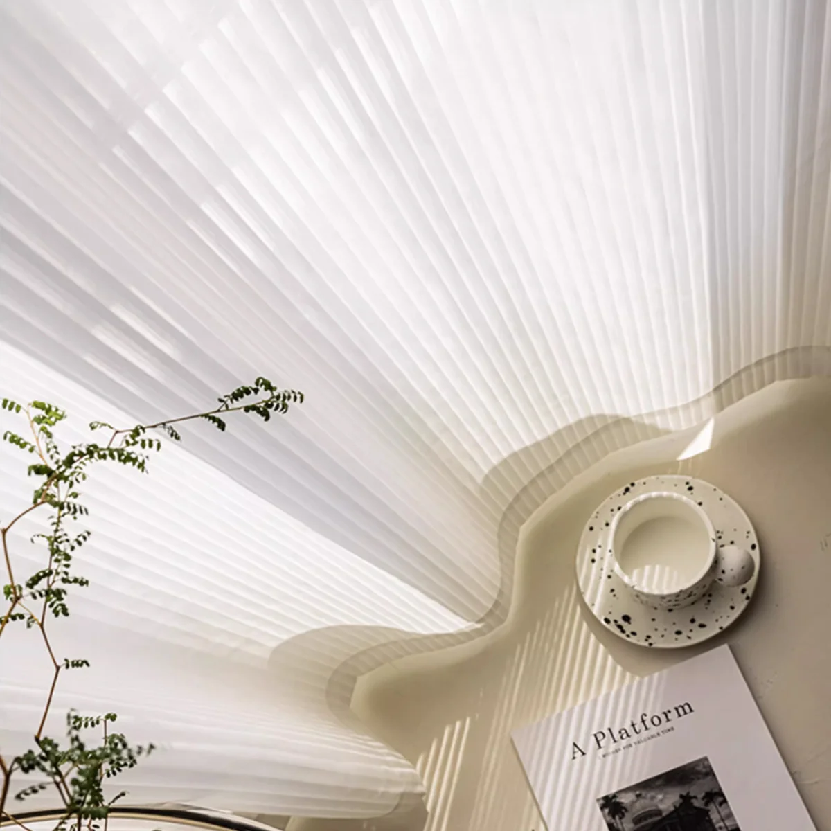 Vertical stripe sheer curtain in soft white voile, styled flat on a bed with a cup and magazine in natural daylight.
