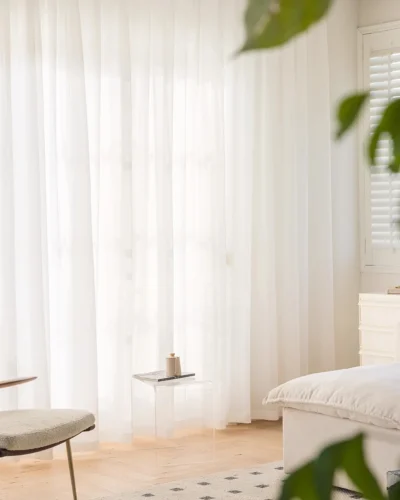 Cloudveil Sheer Curtain – white sheer curtains behind a sofa and indoor plant in a bright living room