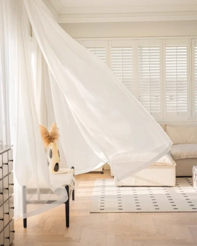 Cloudveil Sheer Curtain – white sheer curtain billowing softly over a low bench in a bright room