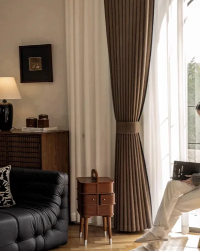 Mocha blackout curtain layered with white sheer in a classic living room