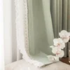 Sage green lace curtain panels in a bright bedroom, floor-length with soft pleats