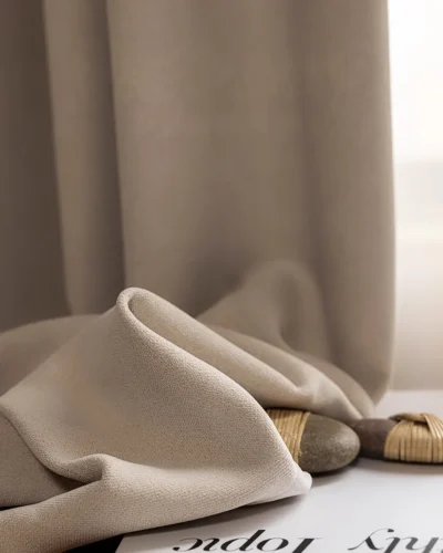 Beige blackout curtain fabric close-up showing smooth soft drape