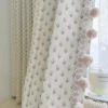 Embroidered curtains with petite floral grid and pom pom trim