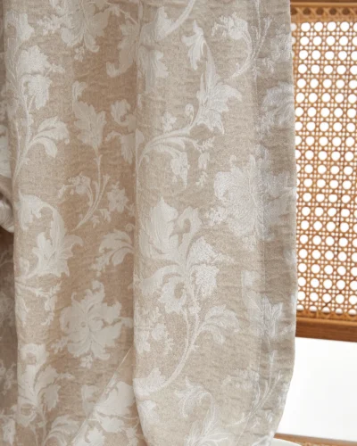 Warm beige floral jacquard sheer curtain pattern with vine motif, light filtering in sunlight