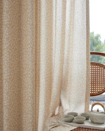 Close-up of warm beige jacquard sheer curtain drape with subtle ditsy floral texture, light filtering