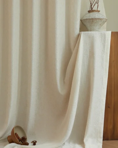 Ivory sheer curtain with subtle relief jacquard texture, calm window styling with ceramic vase