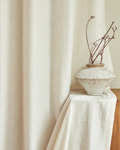 Relief jacquard sheer curtain by the window in ivory, light filtering with soft privacy