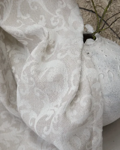 Close-up of Mist Garden grey damask curtain fabric with tonal woven pattern, soft light-filtering texture