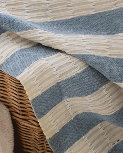 Confetti fringe texture curtain fabric close-up in blue-grey and cream stripes