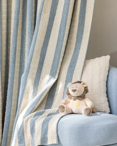 Whisper Stripe Curtain in blue-grey, textured stripe drapes styled by a sofa with soft daylight